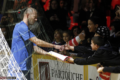 زیدان در حال امضا دادن در جریان مسابقات فوتبال ساحلی در 